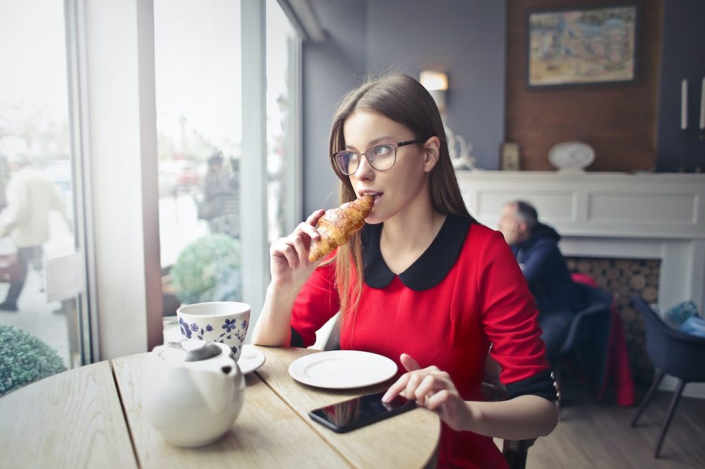 Woman snacking in a cafe